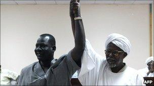Sudanese Al-Amer Mokhtar Papo (R) a leader of the Misserya Arab tribe and his counterpart from the Dinka Ngok tribe, Sultan Qoual Dinq Qoual raise their hands after signing a peace agreement in the town of Kadugli north of Abyei on 13 January 2011