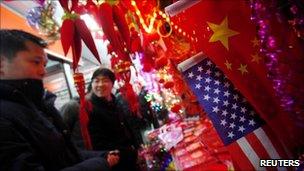 US and Chinese flags are seen at a Chinese new year merchandising market in downtown Shanghai