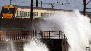Train goes past sea front in Scotland (PA)