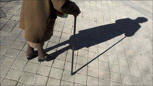 Elderly woman and shadow