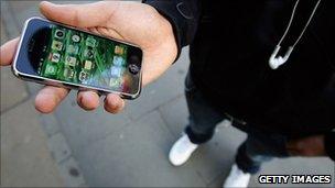 iPhone in man's hand, Getty