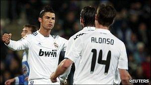 Real Madrid"s Cristiano Ronaldo (l) celebrates a goal with his team-mates Sergio Ramos and Xabi Alonso