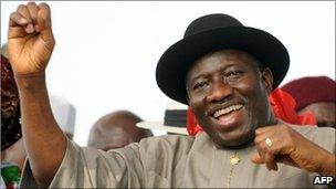 Nigerian President Goodluck Jonathan salutes the crowd on the podium in Lafia on 7 February