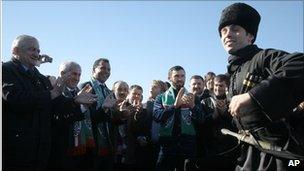 Ruud Gullit (third from left) watches a traditional Chechen dancer perform at Grozny airport, 9 February