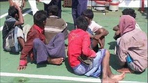 Indian coastguards with migrants who washed up on the Andaman Islands in January 2009