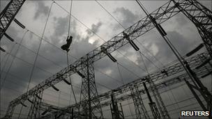 Electrician working on overhead cables