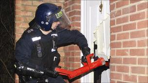Police officer carrying out raid