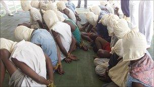 Somali pirates captured in Indian ocean were paraded with their faces covered