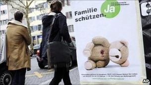 A woman passes a poster in Zurich reading : Protect the Family (file image from 13 Jan 2011)