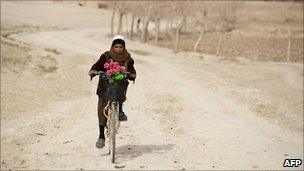 A boy riding in Helmand