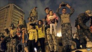 Egyptian Army soldiers celebrate with children on their armoured personnel carrier in Tahrir Square, Cairo, 11 February 2011