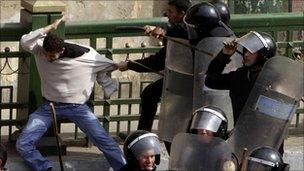 Police beat a protester during clashes in Cairo on 28 January, 2011