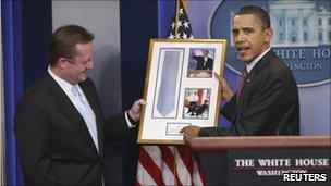 Mr Obama presenting Mr Gibbs with his tie