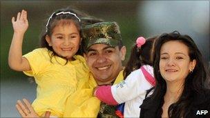 Salin Antonio Sanmiguel hugs his relatives upon his arrival to a military airport in Bogota, Colombia
