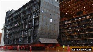 BAE Systems workers assemble part of an aircraft carrier at Govan in Scotland