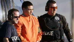 Jose Padilla (in orange prison suit) is escorted for trial in Miami, January 2006
