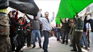 Supporters of the opposition parties carry a giant national flag during Amman protests, 18/02