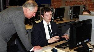 Prince Charles talks to Kristofer Anstey, 14, who was working on pump designs for a Rolls Royce engine during a visit to the JCB Academy.