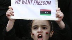 A child joins demonstrators protesting against Libya's Muammar Gaddafi outside the Libyan Embassy in London February 20, 2011.