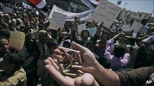 Anti-government protester in Sanaa, Yemen, holds up bullet shells he says were fired by government supporters at protesters the day before - 23 February 2011