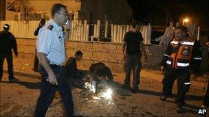 Officials inspect the scene of the rocket attack on Beersheba, Israel (23 Feb 2011)