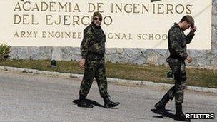 Soldiers walk outside the army academy in Hoyo de Manzanares, Spain, 24 February