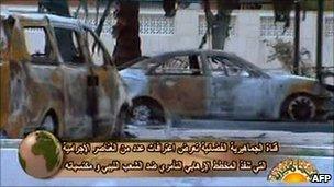 An image grab taken from footage broadcast by the Libyan state television on February 24, 2011 shows burnt cars in Tripoli.