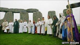 Pagans in traditional costumes at Stonehenge in Somerset
