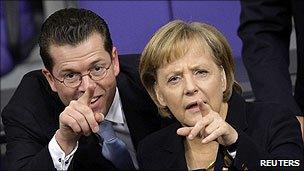 Karl-Theodor zu Guttenberg and Angela Merkel