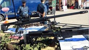 Libyan police stand guard close to a pair of British made high performance tactical sniper rifles, November 2010