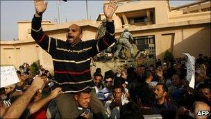 Egyptian protesters in front of a state security building on the outskirts of Cairo