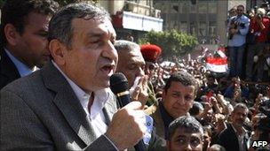 Egyptian Prime Minister Essam Sharaf (left) addresses demonstrators in Cairo's Tahrir Square, 4 March 2011