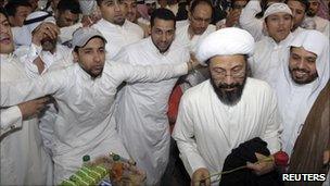 Tawfiq al-Amer (second right) is greeted by his supporters after his release in Al-Ahsa March 6, 2011.