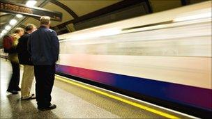 Commuters wait for a Tube train