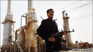 Libyan rebel outside oil refinery