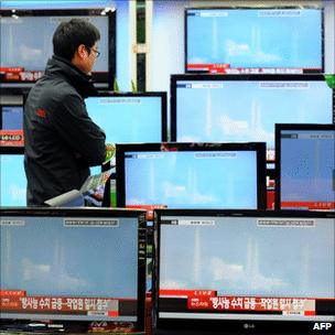 Man watching TVs in South Korea