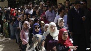 Egyptians queue outside a polling station in Cairo, 19 March