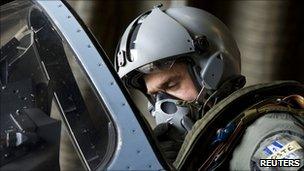 A pilot sits in the cockpit of a French Dassault Mirage 2000-5 aircraft before taking off on a mission to overfly Libyan airspace at Dijon base military handout March 19, 2011.