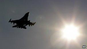 An unidentified Nato jet flies over Italy's Aviano air base, 21 March