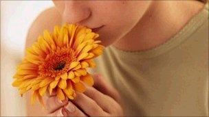 Girl smelling flower