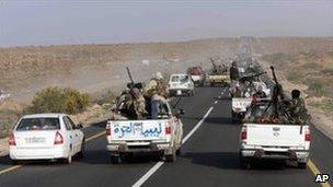 Libyan rebel vehicles pack the road between Ras Lanuf and Sirte, 28 March