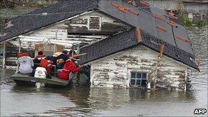 A man is rescued from his home in a flooded section of New Orleans