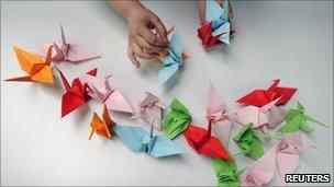 Making origami cranes for the Senbazuru (a thousand cranes) campaign, with participants worldwide