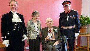 Syd Badland (seated) is pictured with Lloyd FitzHugh, High Sheriff of Clwyd; Mrs Badland and Trefor Jones, Lord-Lieutenant of Clwyd