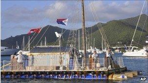 Anthony Smith, right, captains the An-Tiki, as he and crew complete their transatlantic voyage