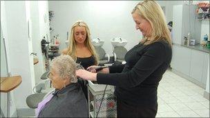 Jackie McNamara and Laurie Brown cutting a customers hair in a local salon