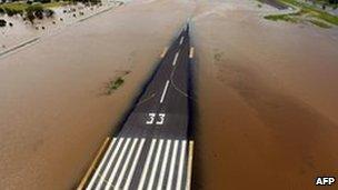 Rising flood waters spread across the runway of the airport at Rockhampton, Australia