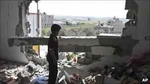 A Palestinian child in his damaged family house in Gaza City, 8 April