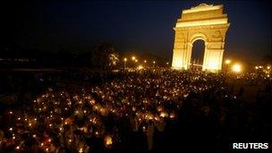 Supporters of Anna Hazare attend a candlelight protest march against corruption in front of India Gate in Delhi April 7, 2011