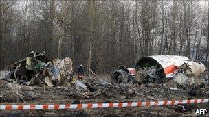 Russian rescuers (R) inspect the wreckage of a Polish government Tupolev Tu-154 aircraft which crashed on 10 April 2010 near Smolensk airport.